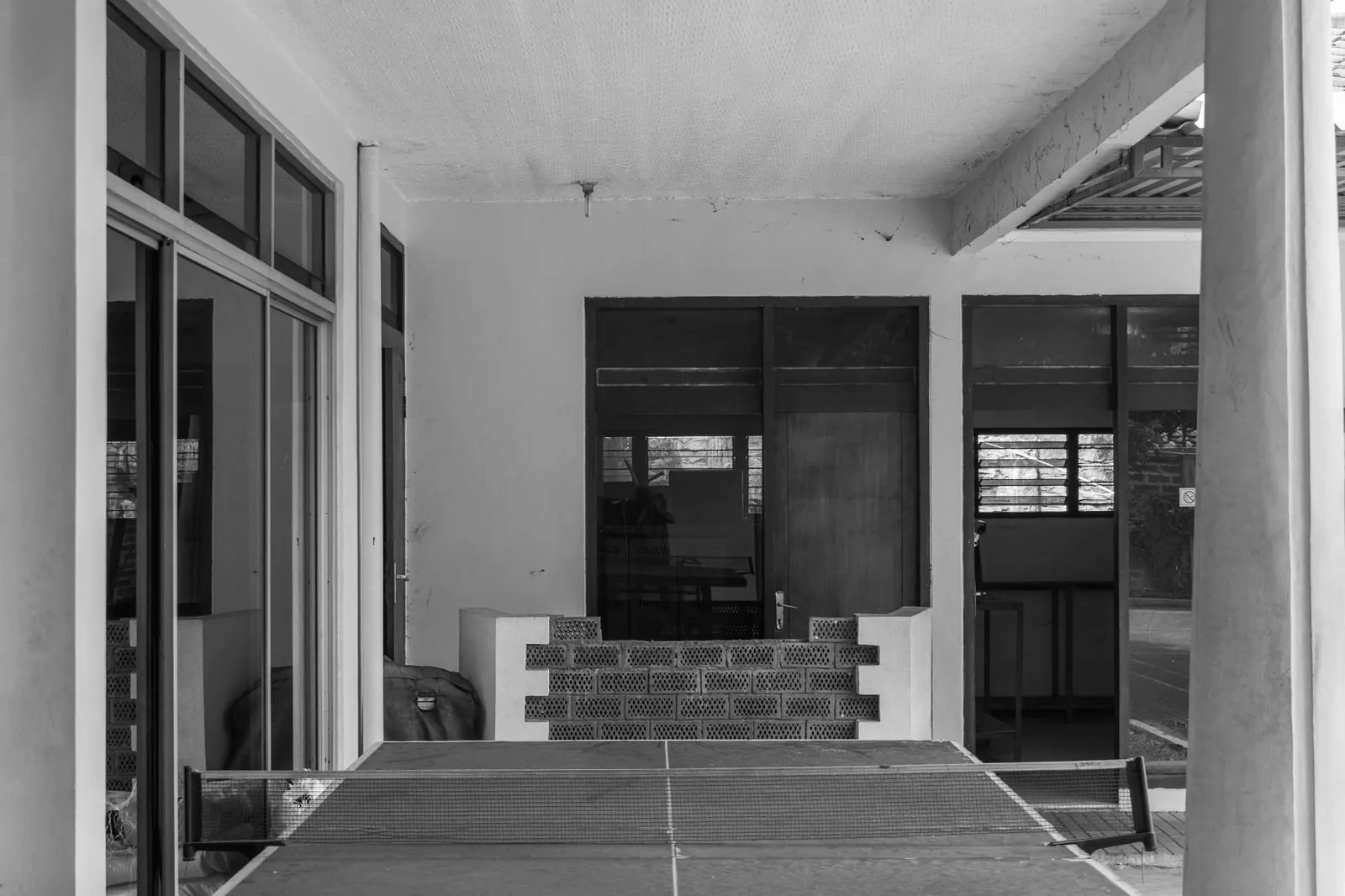Monochrome table tennis table on an outdoor veranda